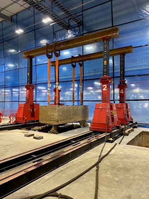 Industrial machinery moving and complex factory equipment relocation process.
