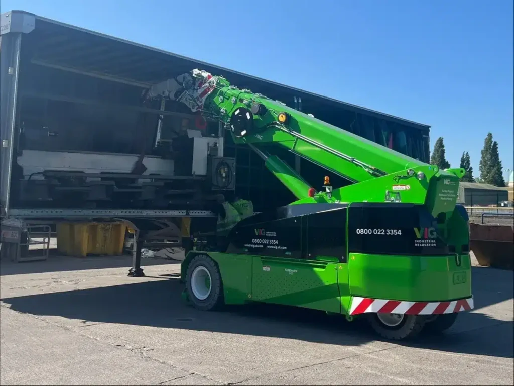 Vanguard Industrial Group MC130 pick and carry crane transporting factory equipment.