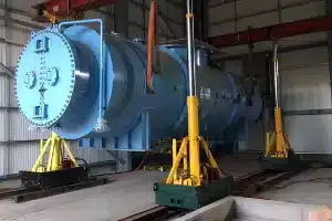 Heavy machine moving operations actively underway in an industrial manufacturing plant.